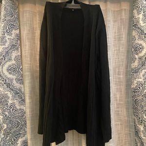 Women’s black cardigan sweater with detail at the bottom.